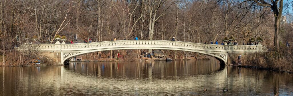 Bow Bridge reflected in the Lake in Central Park during winter