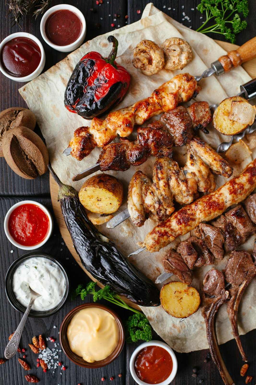 Grilled food, herbs, and bread served as a shared meal