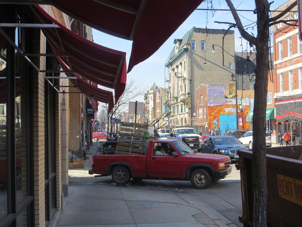 Storefronts and passing traffic on 18th Street in Chicago’s Pilsen neighborhood
